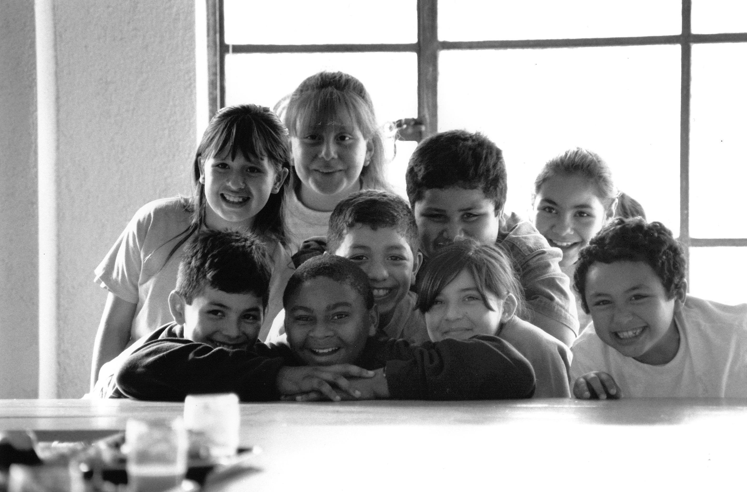 A group of children are posing for the camera.