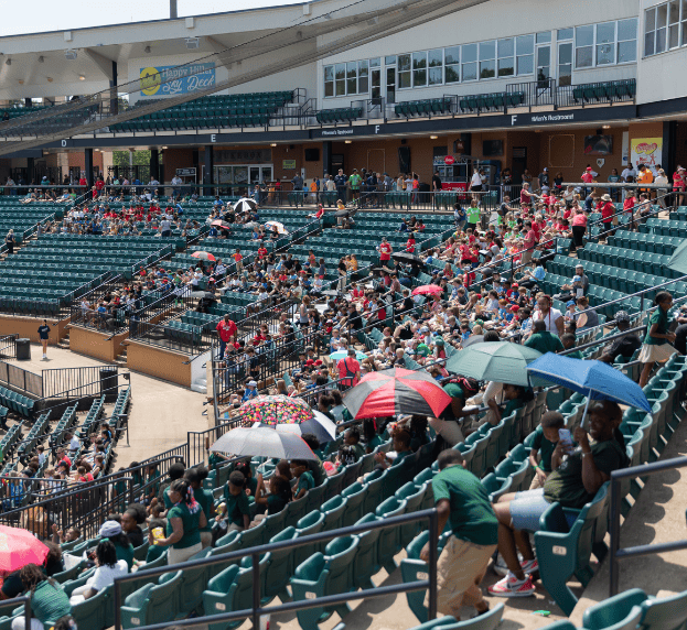 Students are gathered at the local baseball stadium.