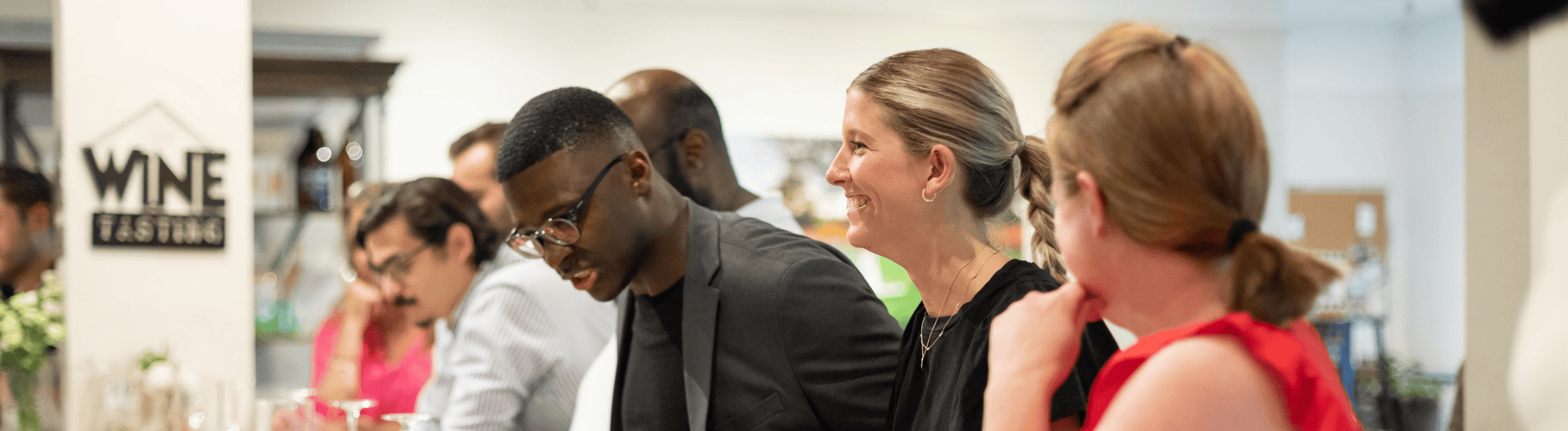 A group of young adults who are part of Emerging Leaders are socializing together.