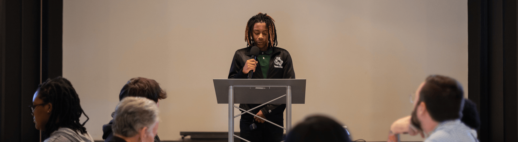 A Jackson Fellow is speaking to the group.