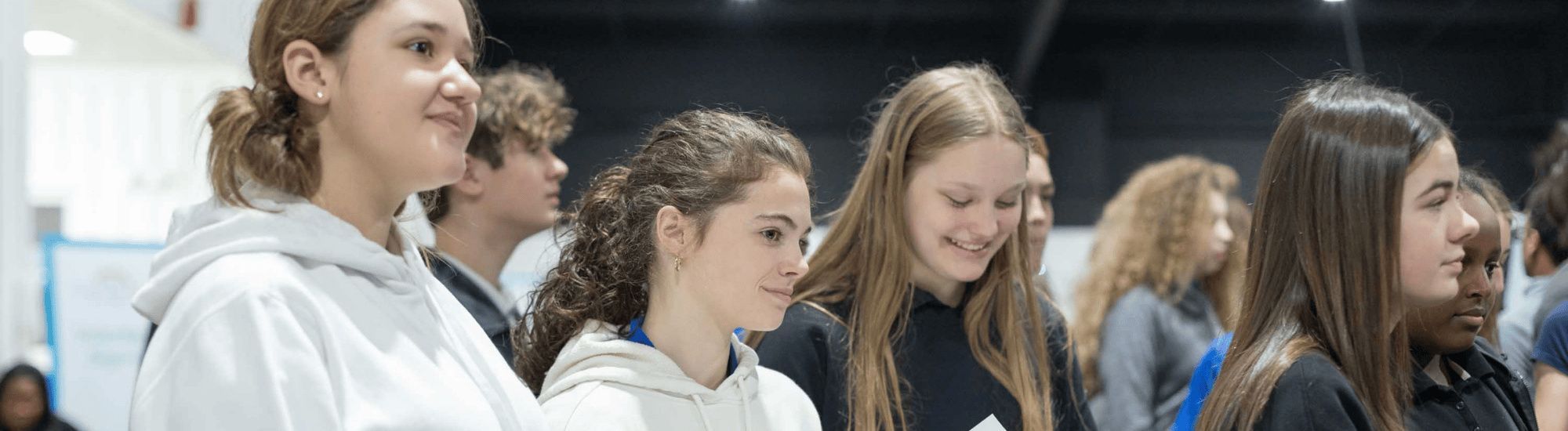 A group of students are awaiting further instruction at the career expo.