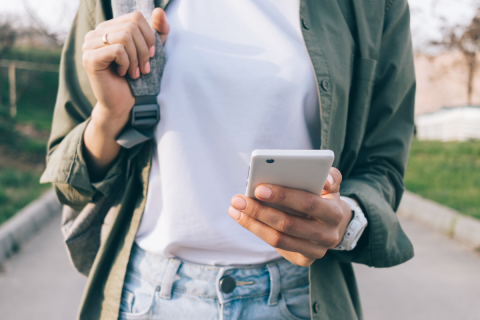 A woman is looking at her cellphone.